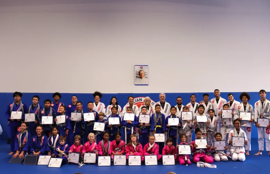 Kids Jiu-Jitsu team receiving a new grade on their belt